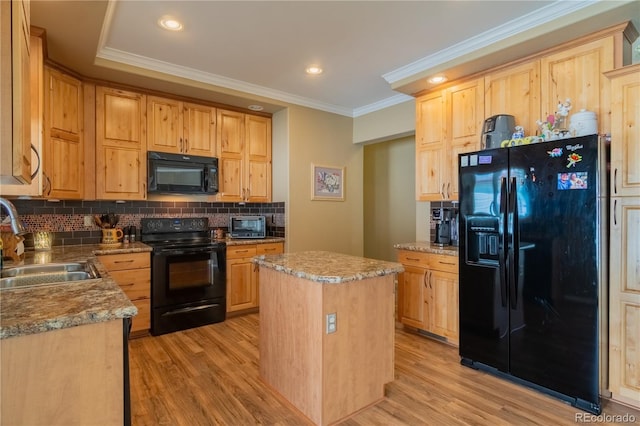 7885 Buckhorn Grn Unit 131, Frederick, CO 80530 - kitchen featuring black appliances, crown molding, light wood-type flooring, tasteful backsplash, and a kitchen island