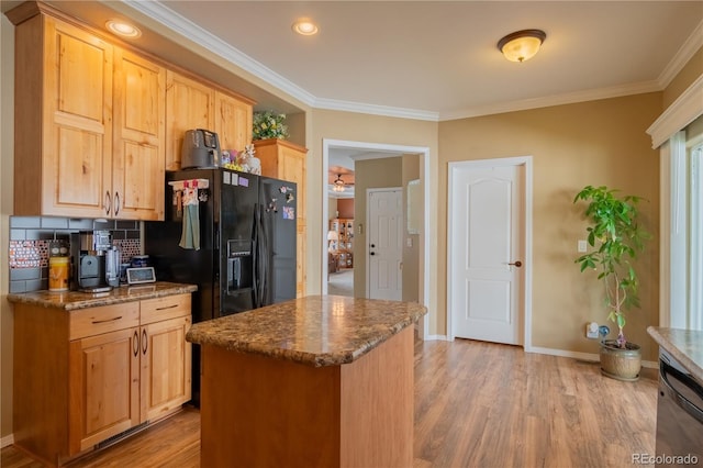 7885 Buckhorn Grn Unit 131, Frederick, CO 80530 - kitchen with black fridge, light wood finished floors, ornamental molding, tasteful backsplash, and light brown cabinetry