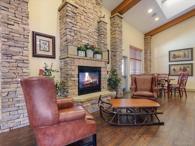 7885 Buckhorn Grn Unit 131, Frederick, CO 80530 - living room with beam ceiling, a fireplace, wood finished floors, and high vaulted ceiling