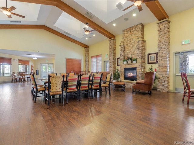 7885 Buckhorn Grn Unit 131, Frederick, CO 80530 - dining room with ceiling fan, high vaulted ceiling, a stone fireplace, wood finished floors, and plenty of natural light