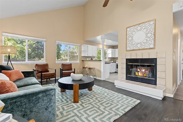 2640 Overlook Dr, Broomfield, CO 80020 - living area with high vaulted ceiling, dark wood finished floors, a tile fireplace, and a ceiling fan