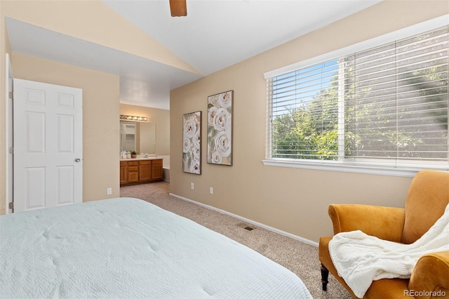 2640 Overlook Dr, Broomfield, CO 80020 - carpeted bedroom with vaulted ceiling, connected bathroom, and ceiling fan