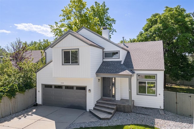 2640 Overlook Dr, Broomfield, CO 80020 - view of front of house with a garage, concrete driveway, a chimney, and roof with shingles