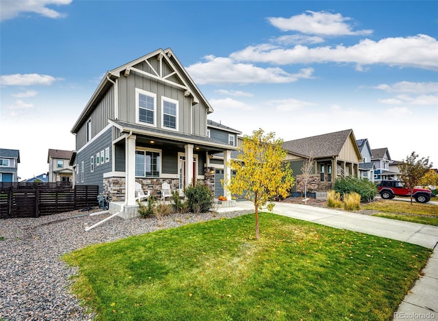 craftsman-style home with covered porch and a front lawn