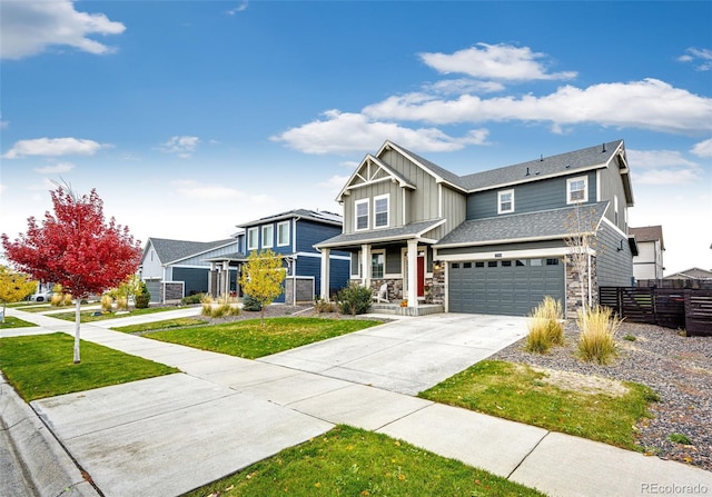 craftsman inspired home featuring a front yard and a garage