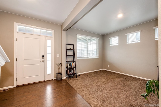 entrance foyer with dark wood-type flooring and baseboards