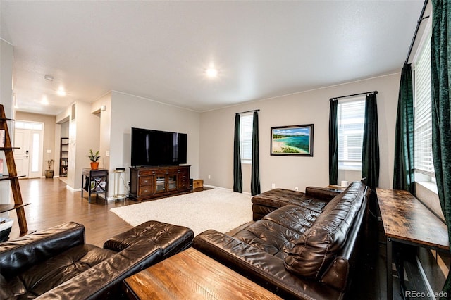 living area featuring baseboards and wood finished floors