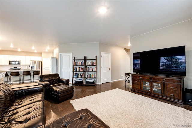 living area featuring dark wood-style floors and baseboards