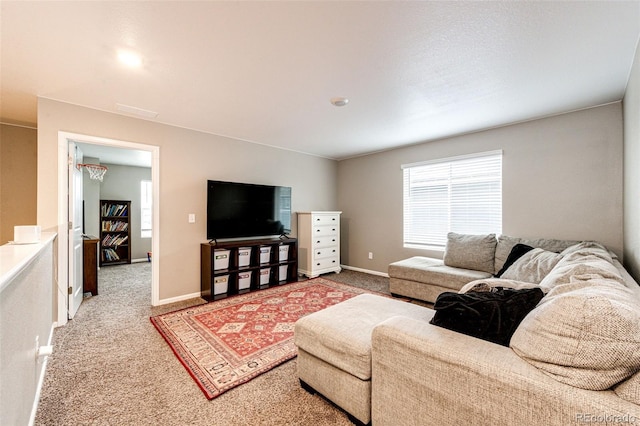 living room featuring carpet and baseboards