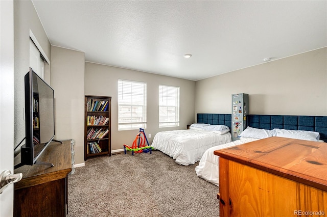 bedroom with carpet flooring and baseboards