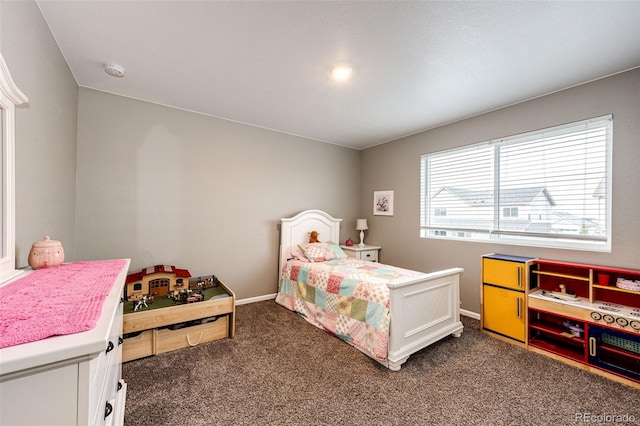 bedroom with baseboards and dark colored carpet