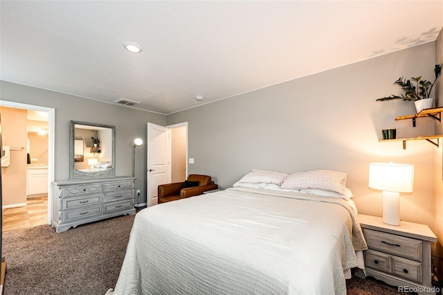 carpeted bedroom featuring visible vents