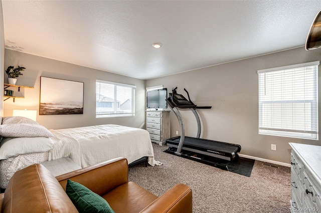 bedroom with carpet flooring, a textured ceiling, and baseboards