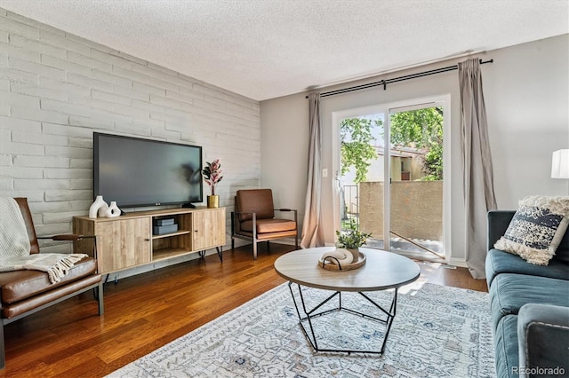 1060 S Parker Rd Unit 25, Denver, CO 80231 - living room featuring a textured ceiling and dark wood finished floors