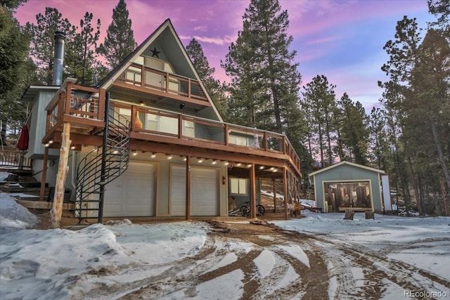 view of front of property featuring an attached garage and stairway