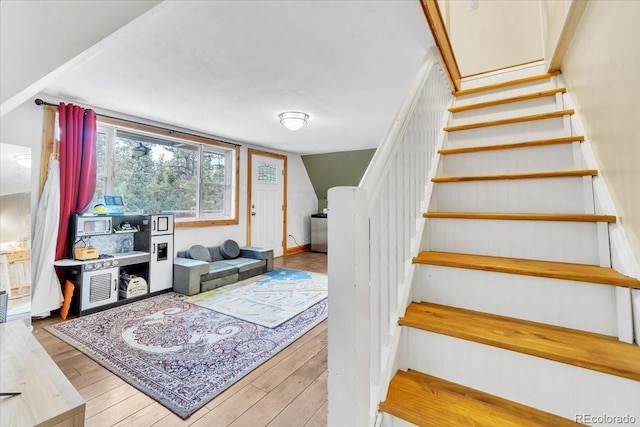 stairway featuring wood finished floors