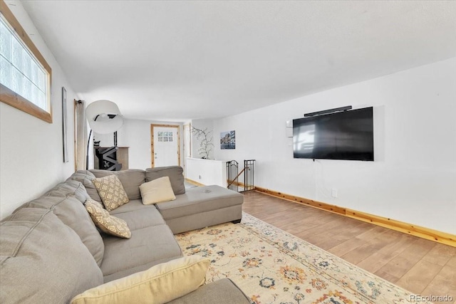 living room with baseboards and wood finished floors