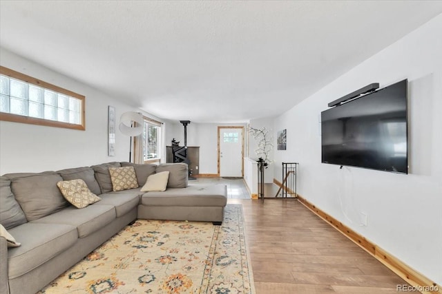 living area featuring baseboards and wood finished floors