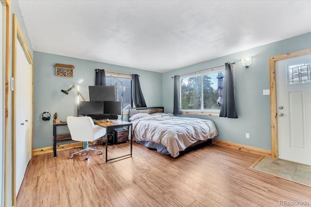 bedroom with baseboards and light wood-style flooring