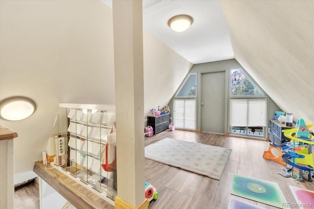 rec room with lofted ceiling and light wood-type flooring