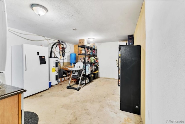 finished basement featuring freestanding refrigerator, a textured ceiling, and water heater