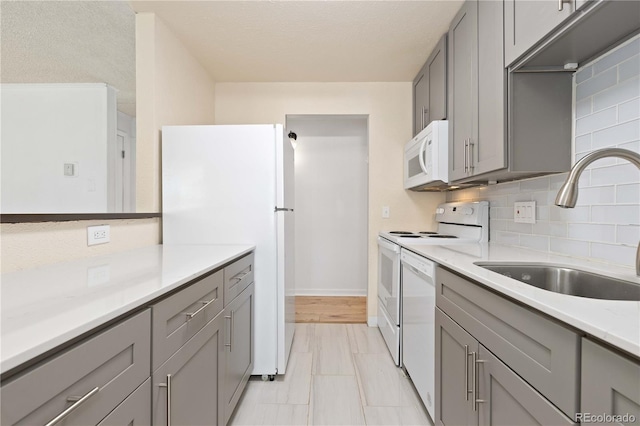 10185 W 25th Ave Unit 33, Lakewood, CO 80215 - kitchen featuring gray cabinetry, white appliances, and a sink