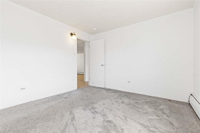 10185 W 25th Ave Unit 33, Lakewood, CO 80215 - empty room with carpet and a baseboard radiator