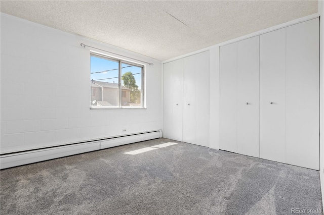 10185 W 25th Ave Unit 33, Lakewood, CO 80215 - unfurnished bedroom with a baseboard radiator, carpet floors, a textured ceiling, and multiple closets