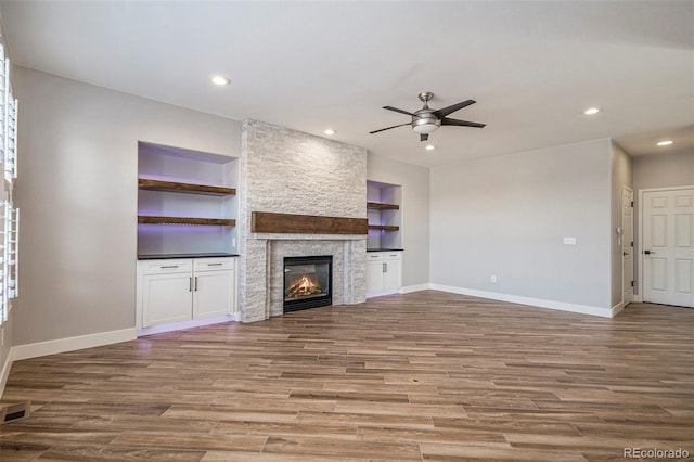 unfurnished living room featuring recessed lighting, baseboards, a ceiling fan, and wood finished floors