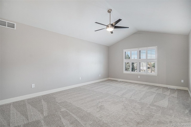 carpeted spare room featuring vaulted ceiling, baseboards, visible vents, and ceiling fan