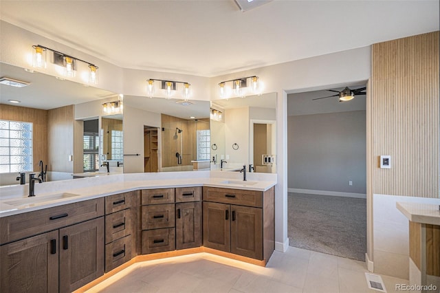 full bathroom featuring ceiling fan, double vanity, visible vents, and a sink