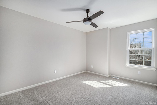 spare room featuring ceiling fan, baseboards, and carpet floors