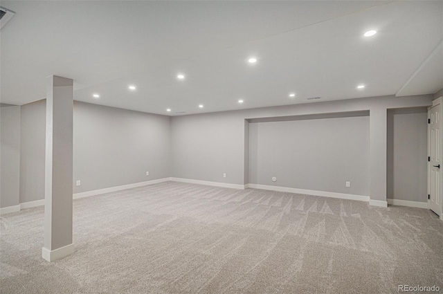 finished below grade area featuring recessed lighting, baseboards, and light carpet