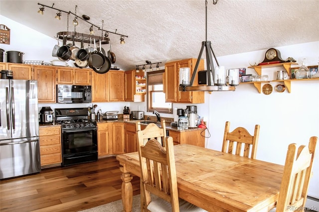 kitchen featuring lofted ceiling, black appliances, open shelves, and dark wood finished floors