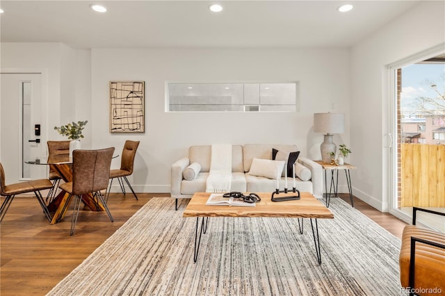 living room with baseboards, recessed lighting, and wood finished floors