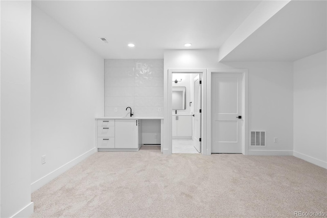 interior space with light colored carpet, visible vents, baseboards, and recessed lighting