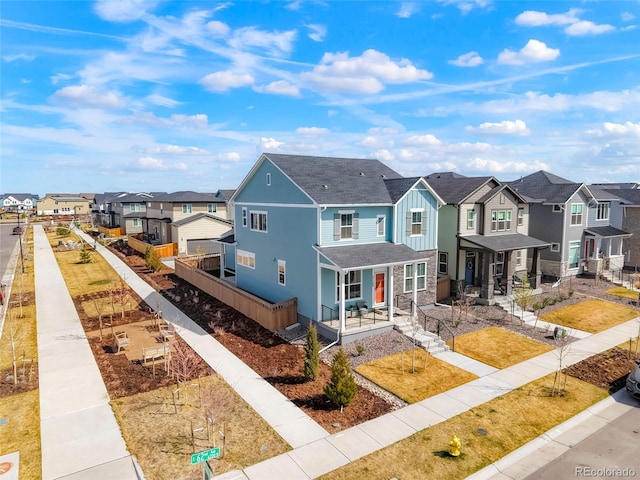 21209 E 62nd Ave, Aurora, CO 80019 - townhome / multi-family property with a residential view, covered porch, board and batten siding, and stone siding
