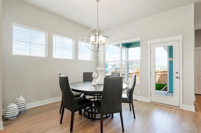 21209 E 62nd Ave, Aurora, CO 80019 - dining area featuring a chandelier and light wood finished floors