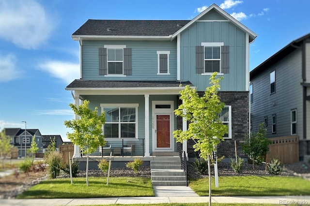 21209 E 62nd Ave, Aurora, CO 80019 - view of front of home featuring board and batten siding, covered porch, and a shingled roof