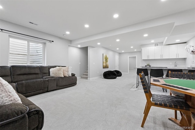 2111 S Franklin St, Denver, CO 80210 - living area with light carpet, recessed lighting, stairway, and wet bar