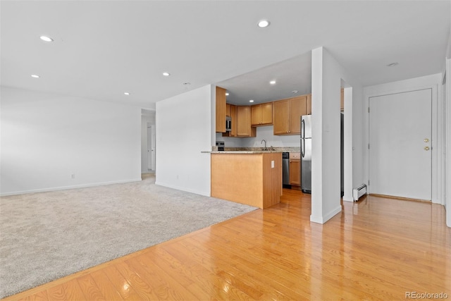 745 Thomas Dr Unit 2, Boulder, CO 80303 - kitchen featuring stainless steel appliances, open floor plan, light wood finished floors, a baseboard radiator, and recessed lighting