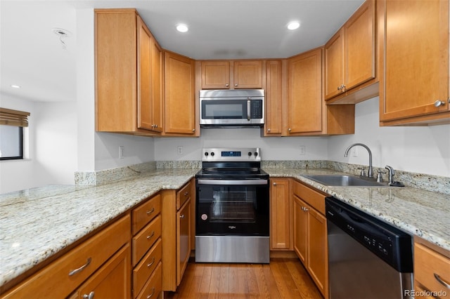 745 Thomas Dr Unit 2, Boulder, CO 80303 - kitchen with appliances with stainless steel finishes, wood finished floors, light stone countertops, recessed lighting, and brown cabinets