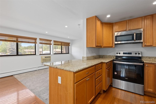 745 Thomas Dr Unit 2, Boulder, CO 80303 - kitchen with appliances with stainless steel finishes, wood finished floors, a peninsula, light stone countertops, and recessed lighting