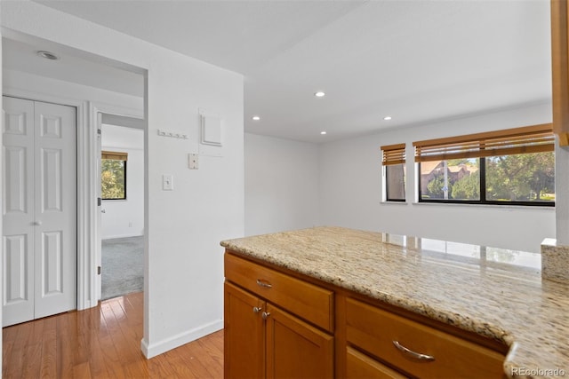 745 Thomas Dr Unit 2, Boulder, CO 80303 - kitchen with light wood-type flooring, recessed lighting, light stone counters, and brown cabinets