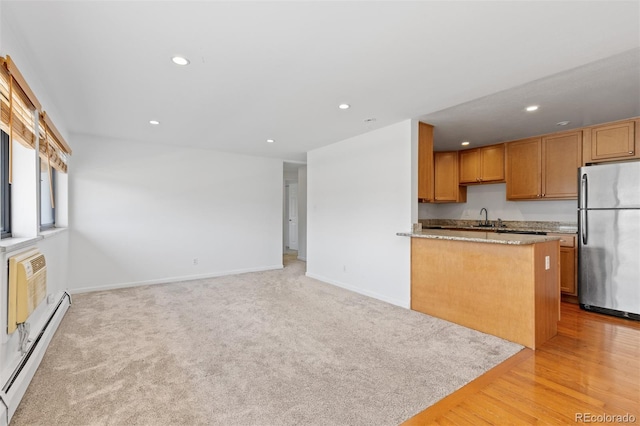 745 Thomas Dr Unit 2, Boulder, CO 80303 - kitchen featuring freestanding refrigerator, baseboard heating, recessed lighting, light stone counters, and a peninsula