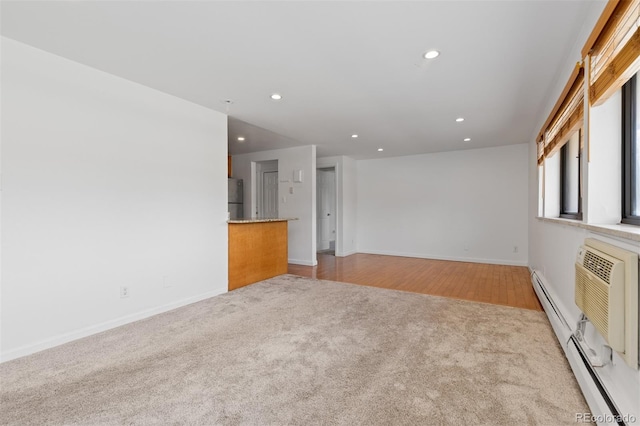 745 Thomas Dr Unit 2, Boulder, CO 80303 - unfurnished living room featuring light carpet, recessed lighting, a baseboard heating unit, and a wall mounted AC