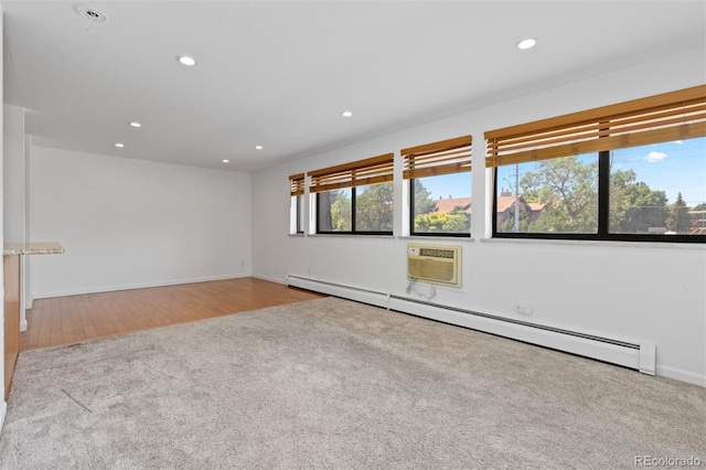 745 Thomas Dr Unit 2, Boulder, CO 80303 - carpeted spare room with a baseboard radiator, recessed lighting, a wall unit AC, and wood finished floors