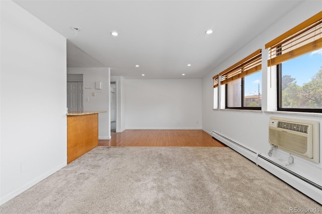 745 Thomas Dr Unit 2, Boulder, CO 80303 - unfurnished living room with light carpet, a baseboard radiator, recessed lighting, and a wall unit AC