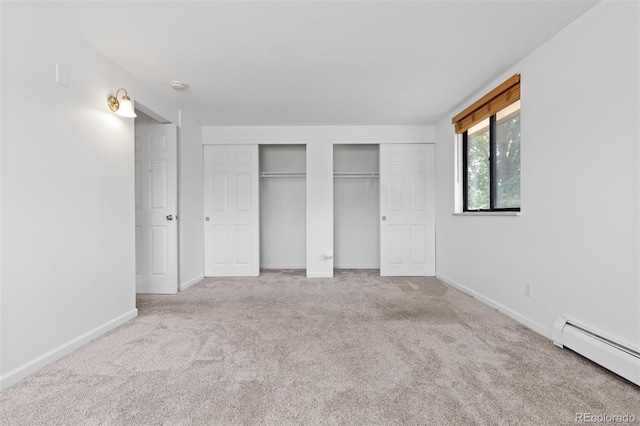 745 Thomas Dr Unit 2, Boulder, CO 80303 - unfurnished bedroom with baseboard heating, two closets, and carpet floors