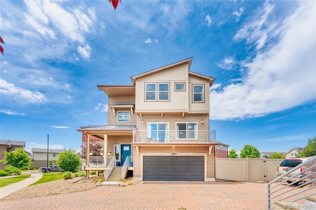 18651 E 53rd Ave, Denver, CO 80249 - view of front of home with an attached garage, decorative driveway, and covered porch